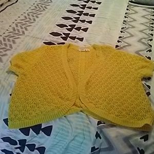 Yellow shrug with buttons down the back